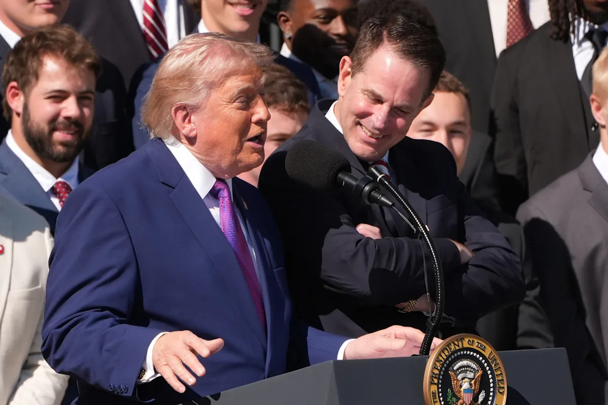 President Trump looks for Curt Cignetti on stage, standing beside him, honoring Indiana football team at White House